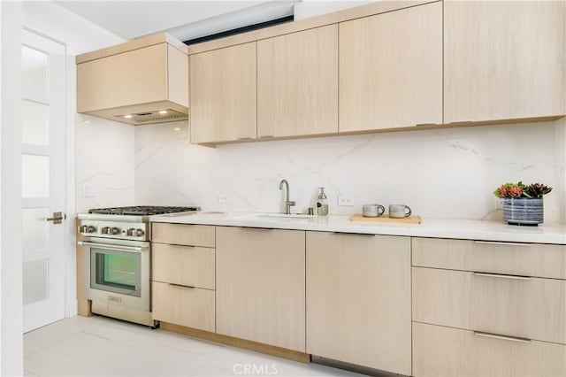 11 Seabreeze Ter, Dana Point, CA 92629 - kitchen featuring stainless steel range, light brown cabinets, a sink, backsplash, and light countertops