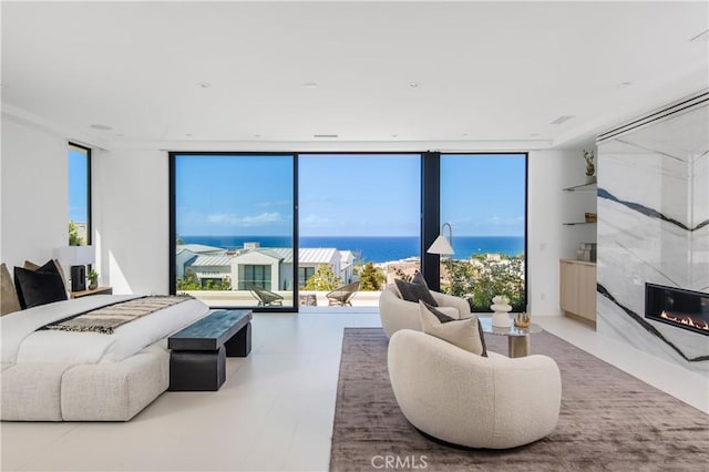 11 Seabreeze Ter, Dana Point, CA 92629 - living area featuring a high end fireplace, expansive windows, and a water view