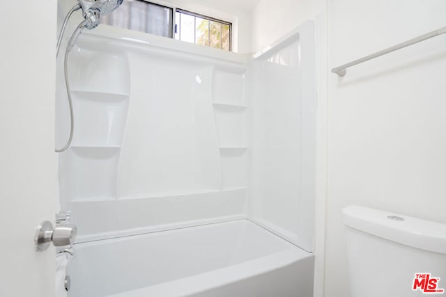 bathroom featuring shower / tub combination and toilet