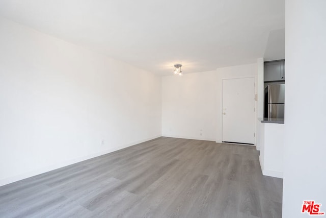 empty room with light hardwood / wood-style flooring