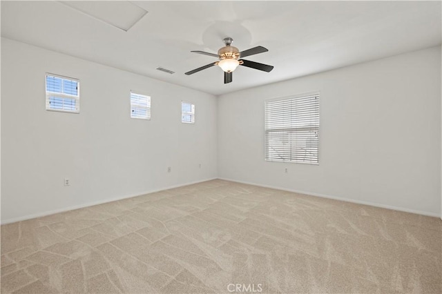 unfurnished room featuring light carpet and ceiling fan