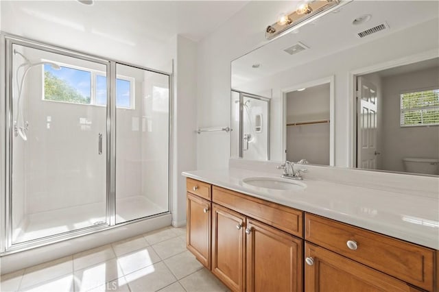 bathroom with vanity, tile patterned floors, walk in shower, and a healthy amount of sunlight