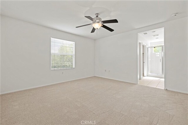 unfurnished room with light carpet and ceiling fan