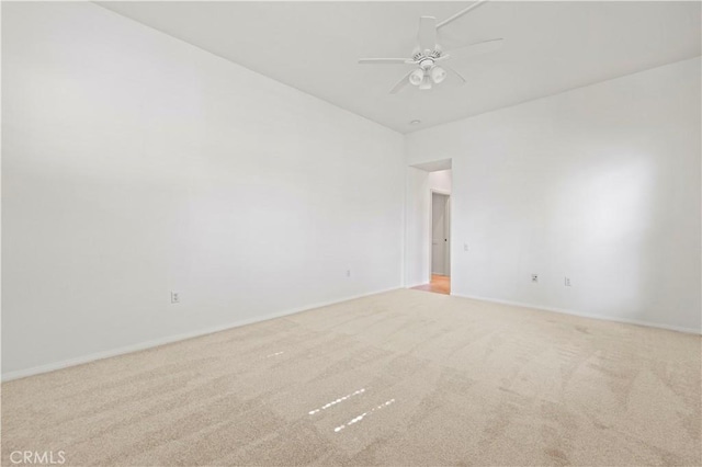 empty room featuring light colored carpet and ceiling fan