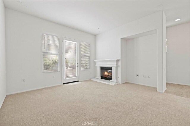 unfurnished living room with light carpet