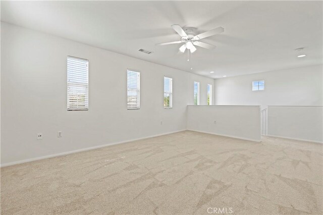 unfurnished room featuring light carpet and ceiling fan