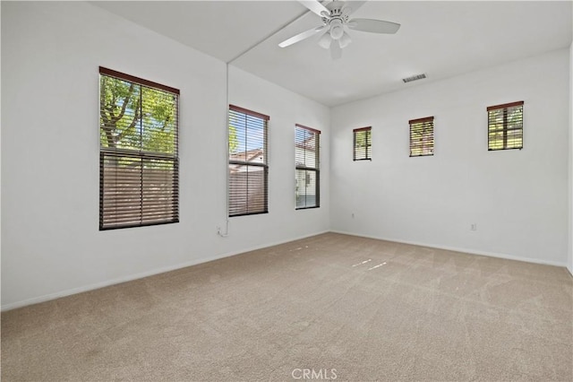 carpeted empty room featuring ceiling fan