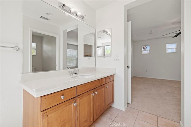 bathroom featuring ceiling fan, tile patterned flooring, vanity, and toilet