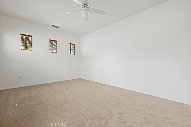 empty room featuring ceiling fan and carpet floors