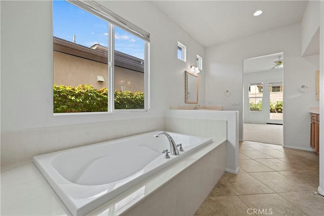 bathroom featuring tile patterned flooring, vanity, and a healthy amount of sunlight