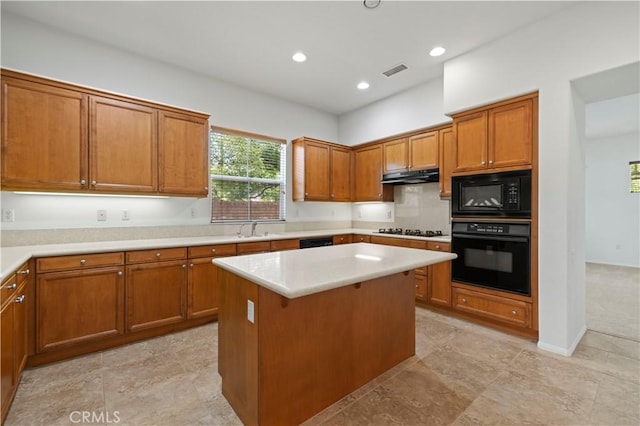 kitchen featuring sink, a kitchen island, and black appliances