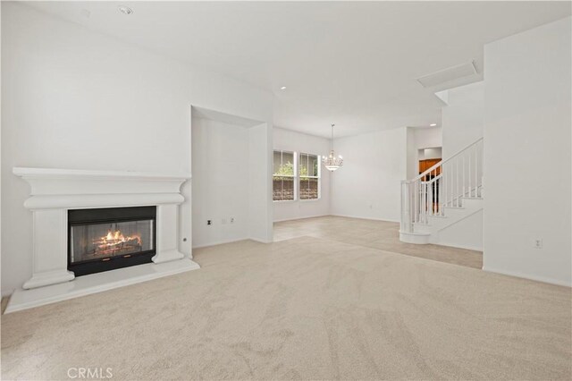 unfurnished living room with a chandelier and light colored carpet