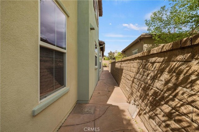 view of property exterior with a patio area