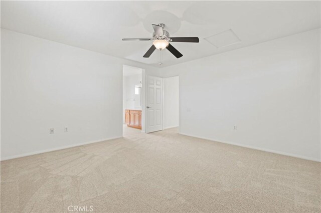 unfurnished room with light colored carpet and ceiling fan