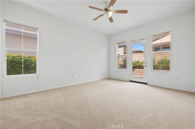 carpeted spare room with ceiling fan