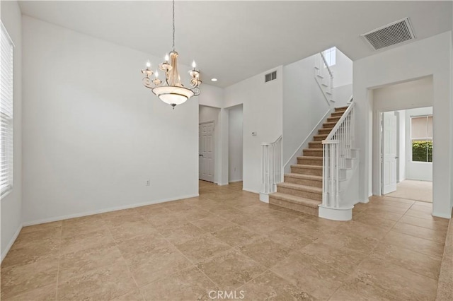 spare room featuring a notable chandelier