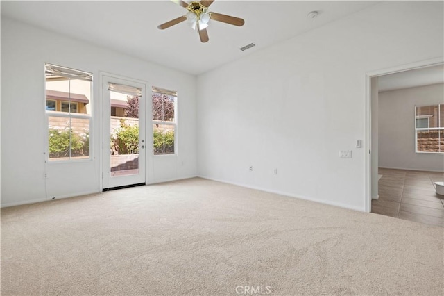 carpeted spare room featuring ceiling fan