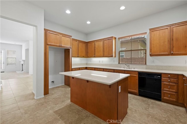 kitchen with black dishwasher, a kitchen island, and sink