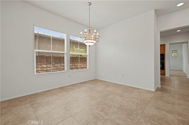 unfurnished room featuring an inviting chandelier