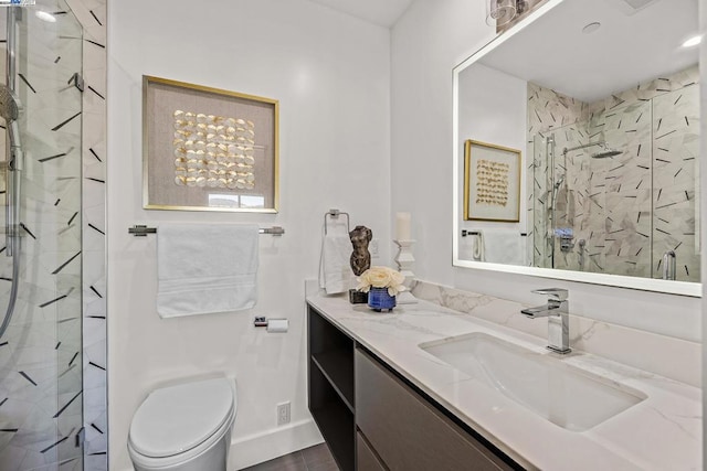 bathroom with walk in shower, vanity, and toilet