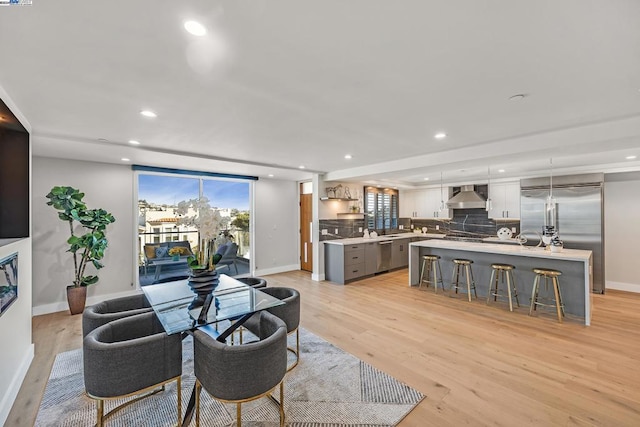 living room with light hardwood / wood-style floors and sink