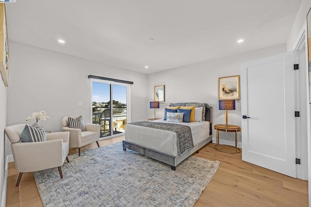 bedroom with light hardwood / wood-style flooring and access to exterior