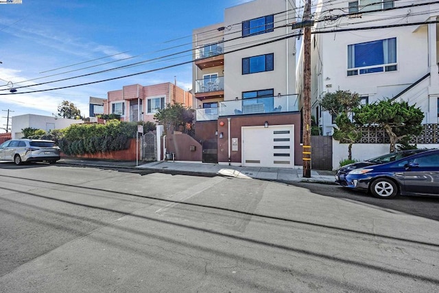 view of front of property featuring a balcony and a garage