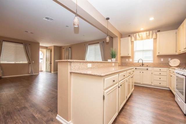 kitchen with kitchen peninsula, white range oven, hanging light fixtures, and dark hardwood / wood-style flooring