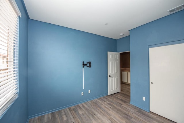 unfurnished bedroom with wood-type flooring