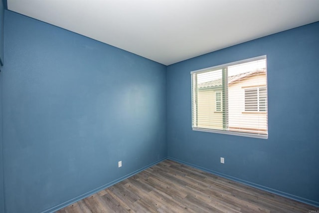 unfurnished room with dark wood-type flooring