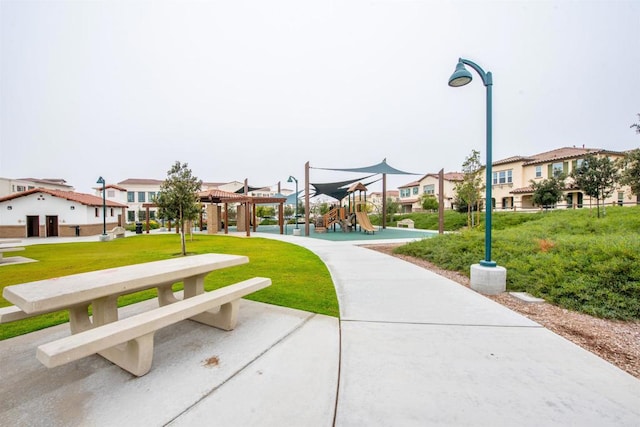 view of home's community with a lawn and a playground