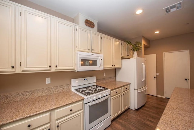 kitchen featuring dark wood-type flooring and white appliances