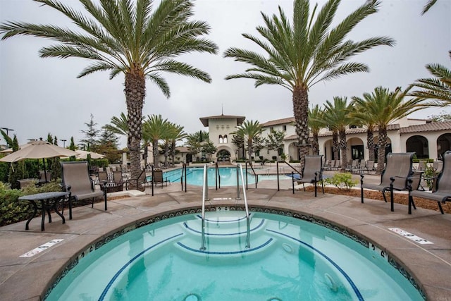 view of swimming pool featuring a patio area and a community hot tub