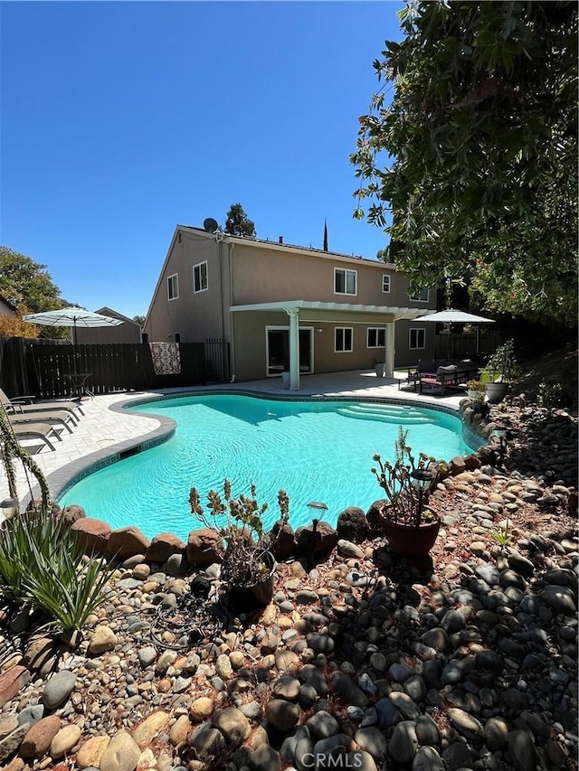 view of swimming pool with a fenced in pool, a patio area, and fence