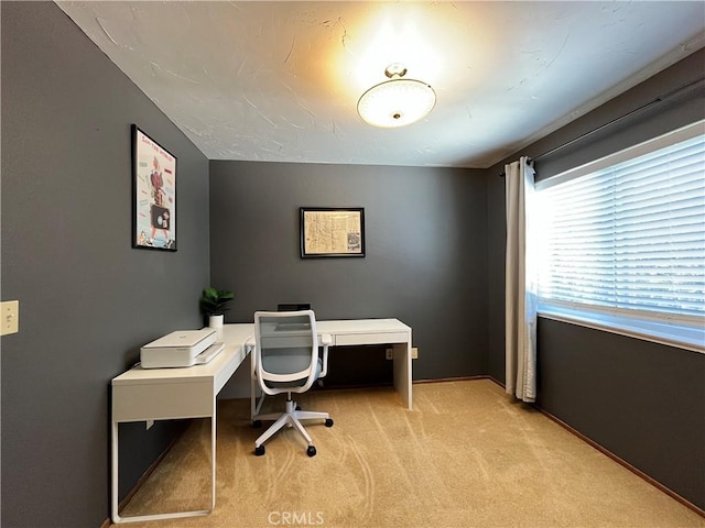 office area with baseboards and light carpet