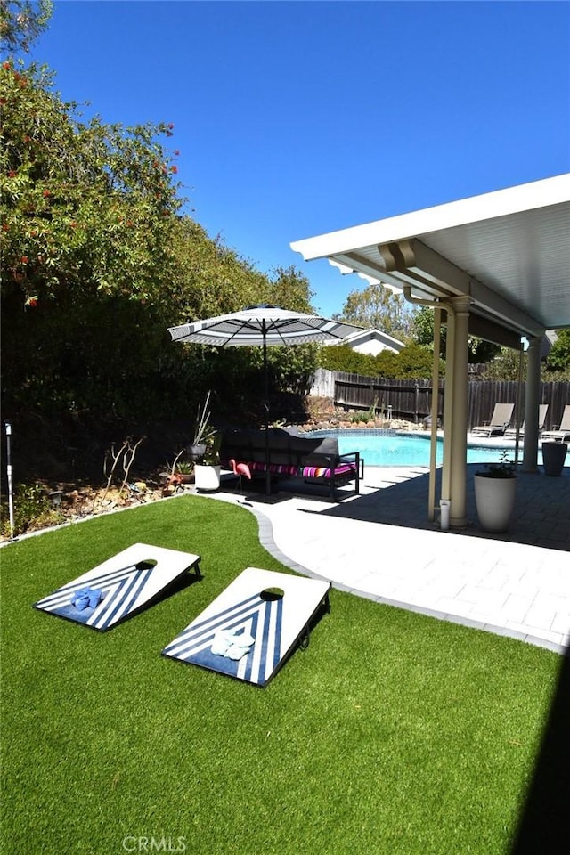 view of pool featuring a fenced in pool, a fenced backyard, a lawn, and a patio area