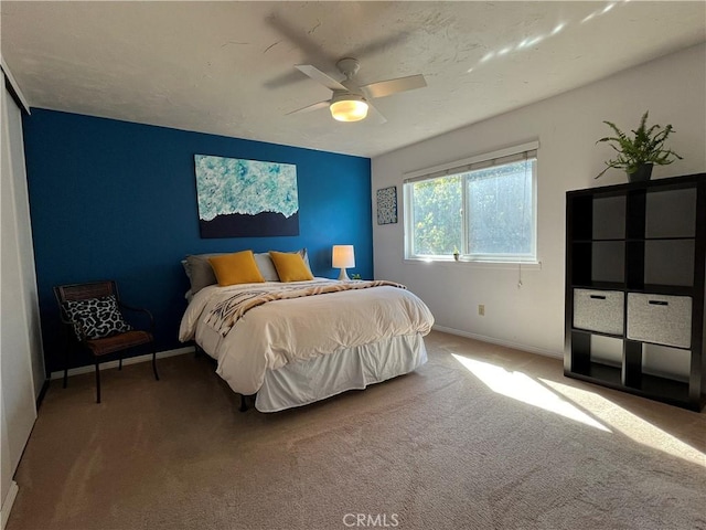 bedroom featuring carpet floors, baseboards, and a ceiling fan
