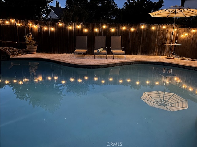 pool at night with a patio