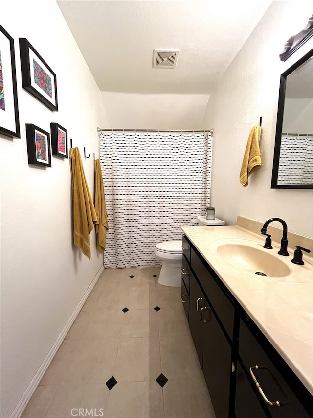 bathroom featuring a shower with shower curtain, vanity, toilet, and tile patterned floors