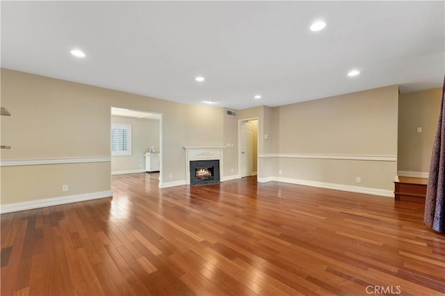 unfurnished living room with hardwood / wood-style floors