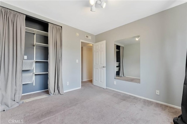 unfurnished bedroom featuring a closet and light colored carpet