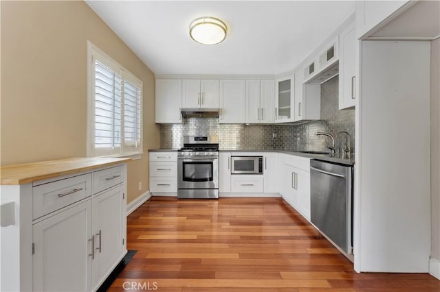 kitchen featuring white cabinetry, light hardwood / wood-style flooring, and appliances with stainless steel finishes