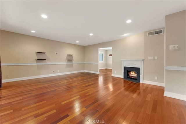 unfurnished living room with hardwood / wood-style flooring