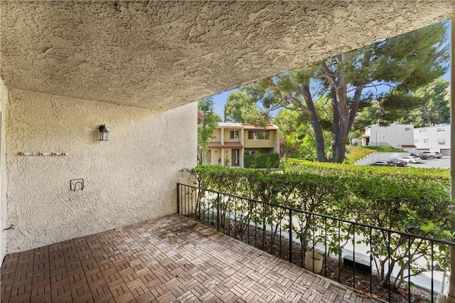 view of patio featuring a balcony