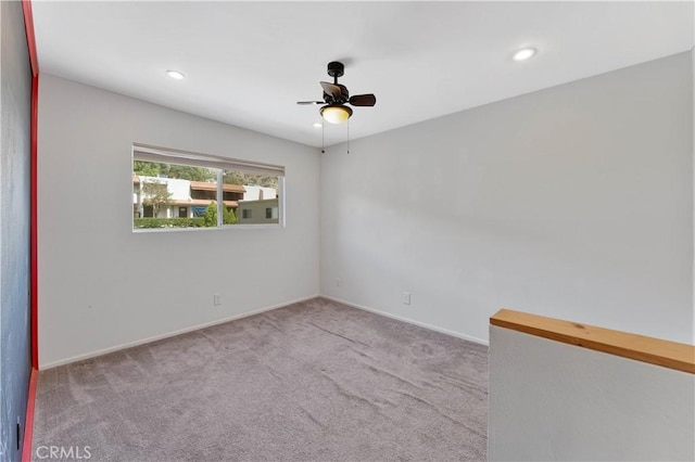 carpeted empty room featuring ceiling fan