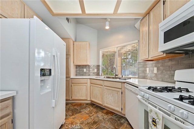 kitchen featuring tasteful backsplash, sink, white appliances, and light brown cabinets