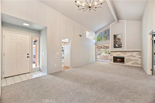 unfurnished living room with beamed ceiling, light colored carpet, a notable chandelier, and high vaulted ceiling