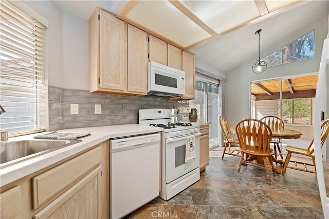 kitchen featuring vaulted ceiling, hanging light fixtures, light brown cabinets, white appliances, and decorative backsplash