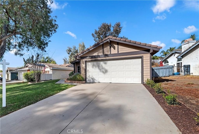 view of front of house with a garage and a front lawn