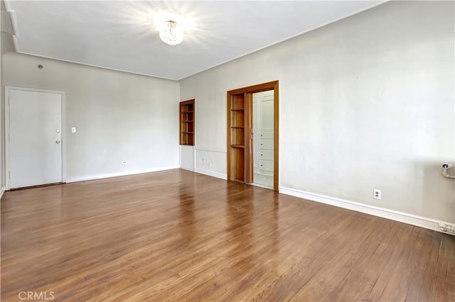 unfurnished room featuring hardwood / wood-style floors